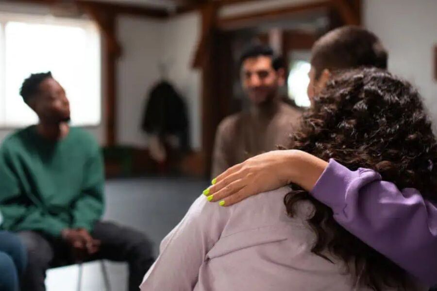 Therapist offering addiction counseling support in a group setting