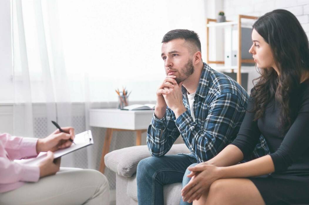 Mental health professional conducting a clinical interview to diagnose psychiatric conditions and assess patient care needs