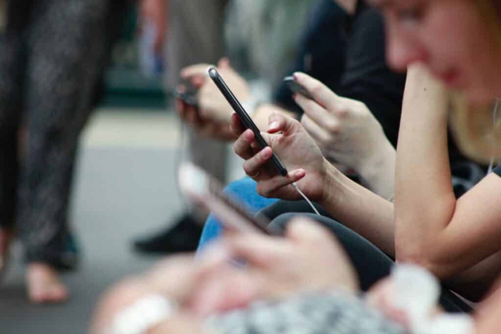 line of people using their phones